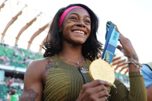 Sha'Carri Richardson poses with her gold medal after winning the women's 100 meter final at the 2024 U.S. Olympic Team Track & Field Trials