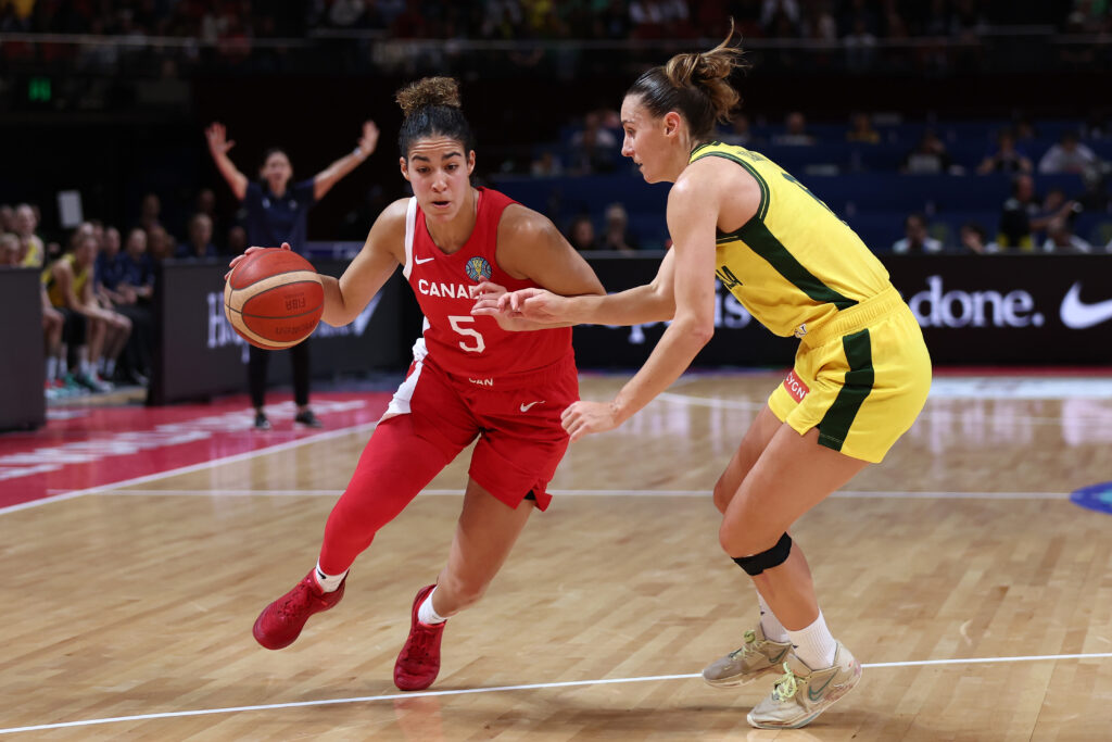 Canadian Olympic basketball player Kia controls the ball during a game against Australia