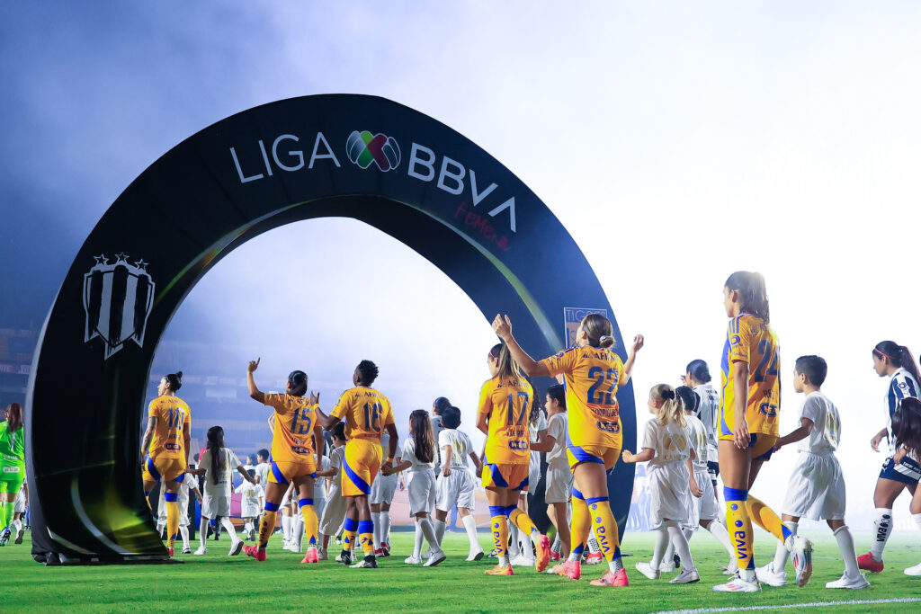 liga mx summer cup players from Tigres femenil and Monterrey femenil walk to the pitch