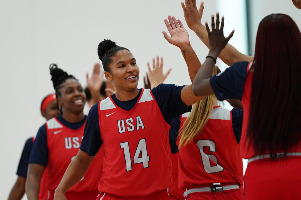 Alyssa Thomas high-fives her Team USA teammates at 2024 WNBA All-Star Weekend