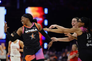 Arike Ogunbowale of Team WNBA celebrates with Caitlin Clark and Allisha Gray #15 of Team WNBA at the 2024 WNBA All-Star Game vs. Team USA