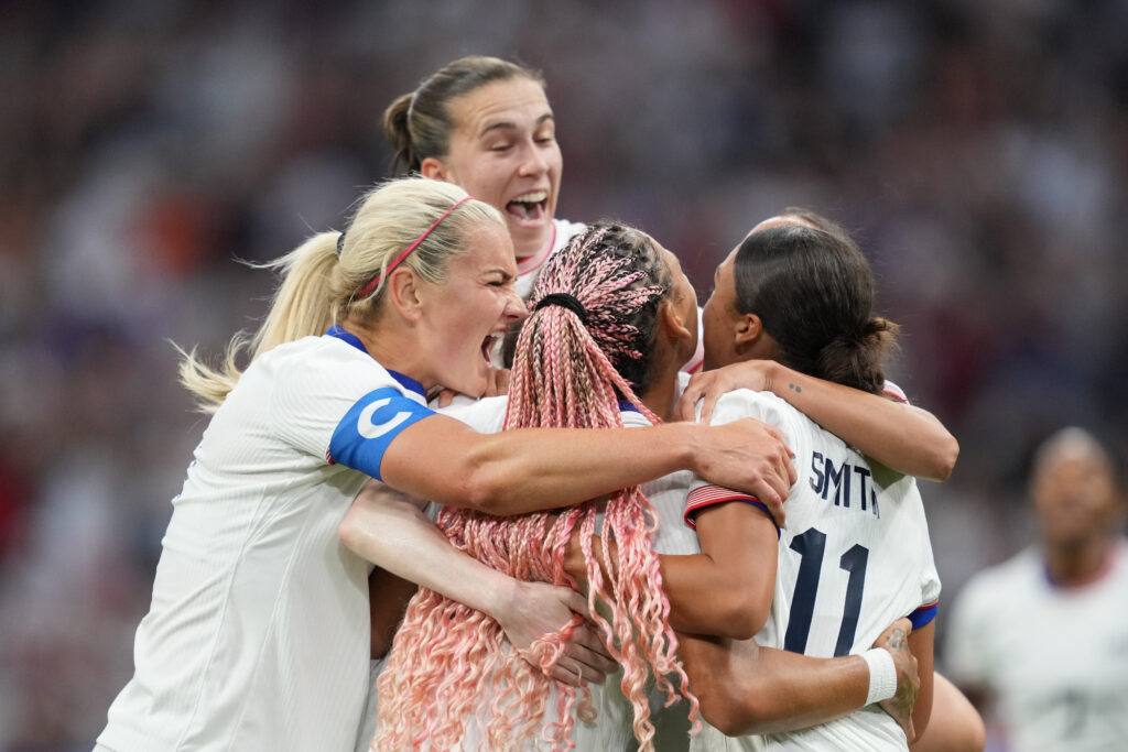 Sam Coffey, Lindsay Horan, Trinity Rodman, and Sophia Smith celebrate a goal in the USWNT's win over Germany at the olympics