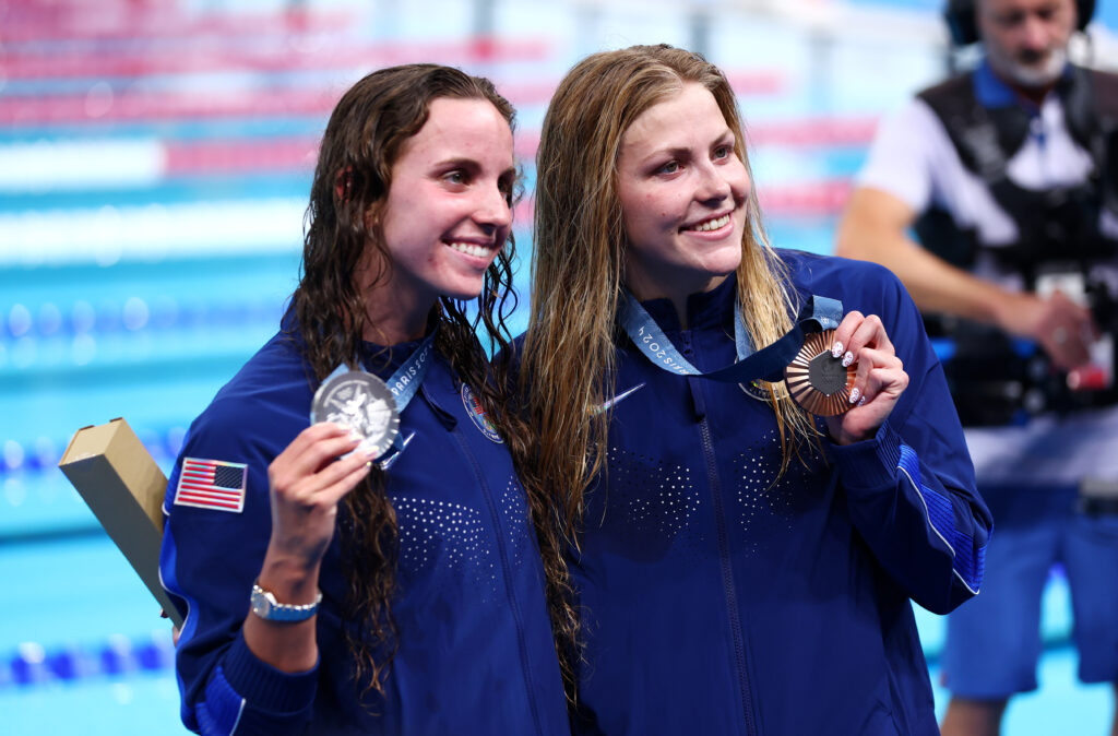 Team USA's Regan Smith and Katharine Berkoff pose with their silver and bronze medals in the 100-meter backstroke.