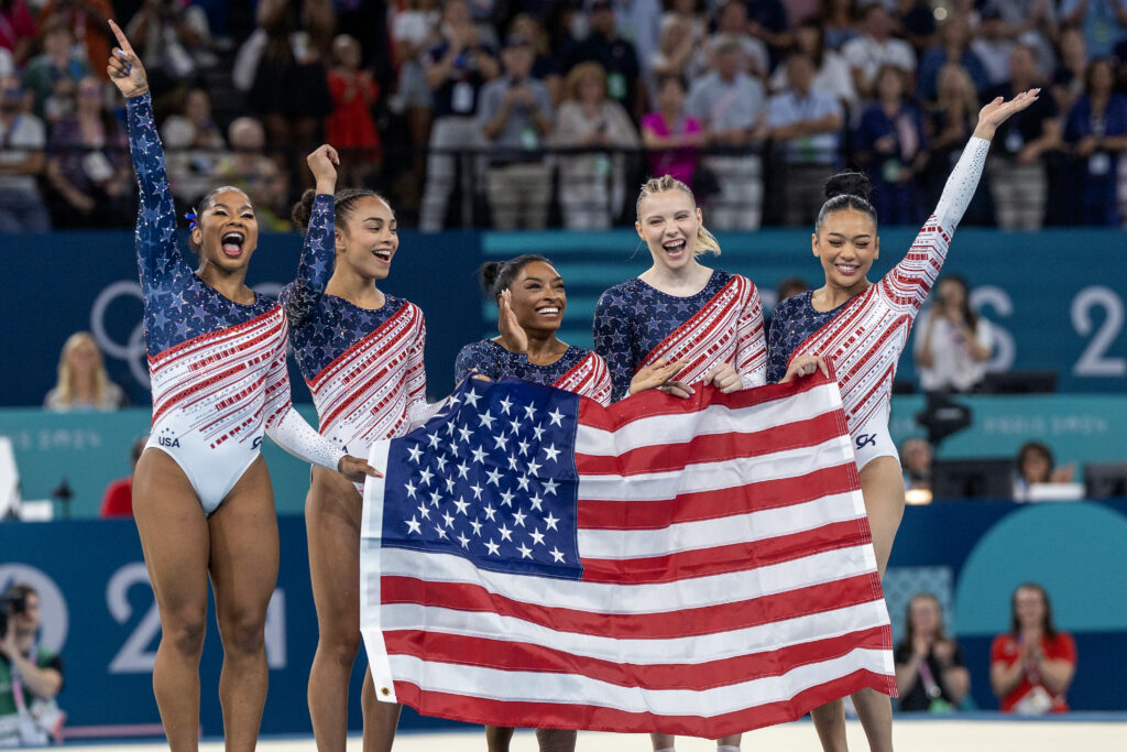 Team USA gymnastics celebrates their Olympics gold medal win