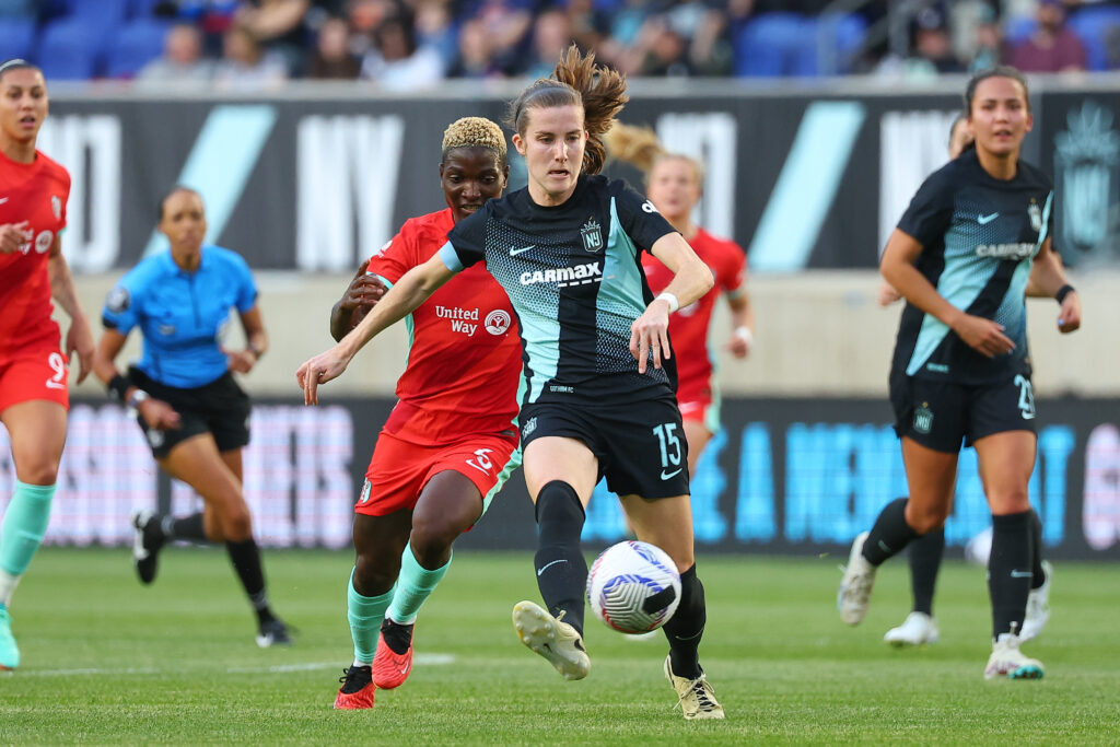 Gotham defender Tierna Davidson sweeps the ball away from Kansas City striker Temwa Chawinga in their April 14th match.