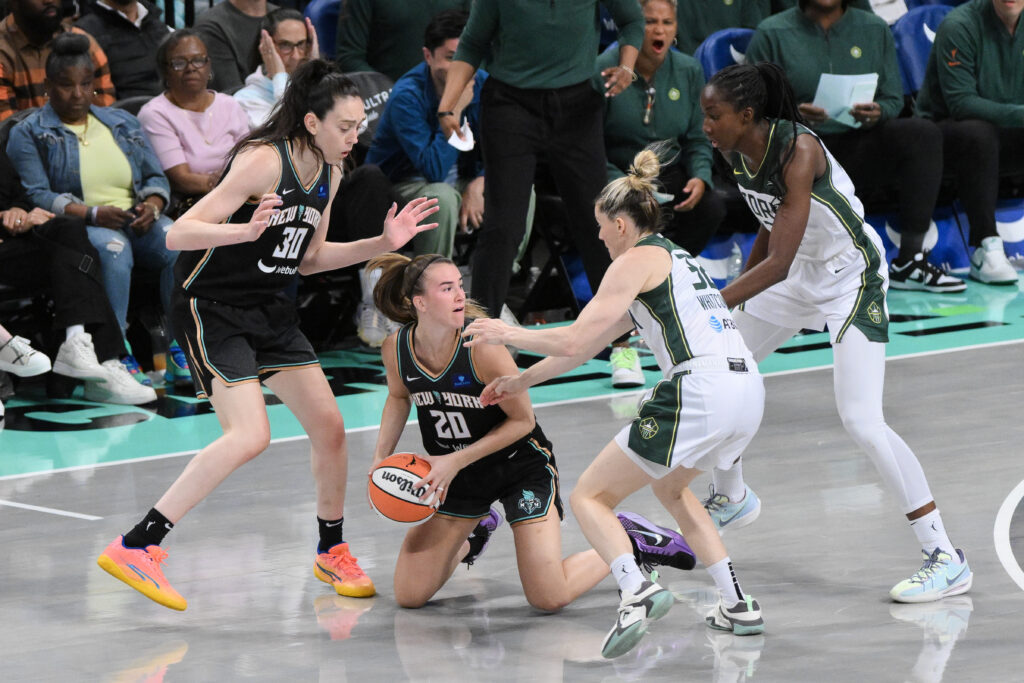 New York Liberty guard Sabrina Ionescu on the floor in a WNBA game against the Seattle Storm.