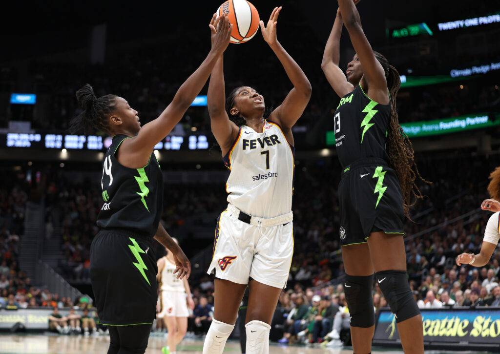 Indiana's Aliyah Boston muscles up a shot between two Seattle Storm defenders