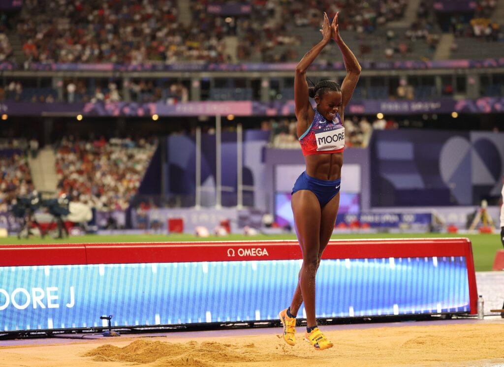 Team USA's Jasmine Moore celebrates her Olympic bronze medal-winning triple jump