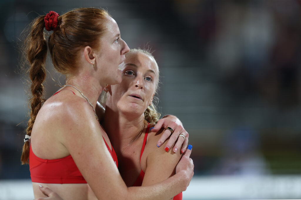 Team USA Beach Volleyball team Kelly Cheng and Sara Hughes hug after losing their Olympic quarterfinal