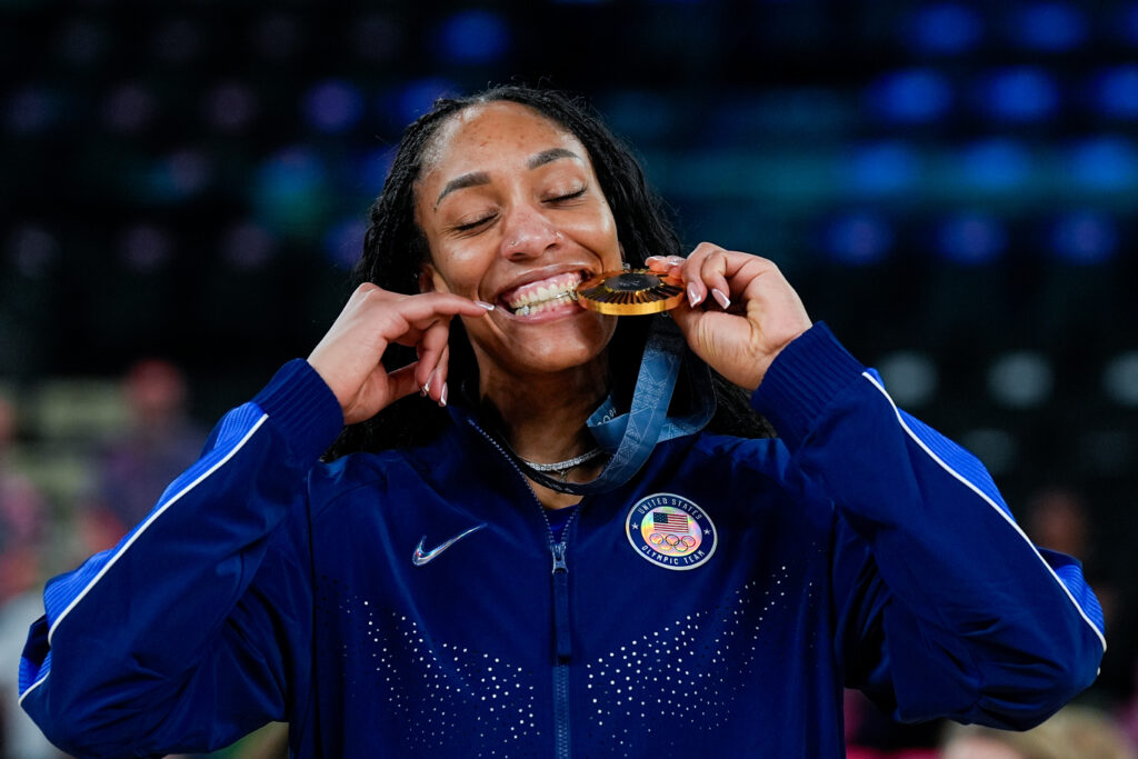 A'ja Wilson bites her Olympic gold medal