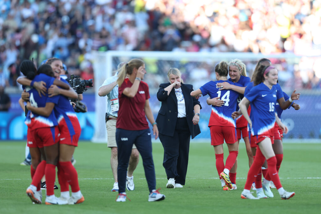 USWNT coach Emma Hayes and her players celebrate winning the gold medal match at the Paris Olympics