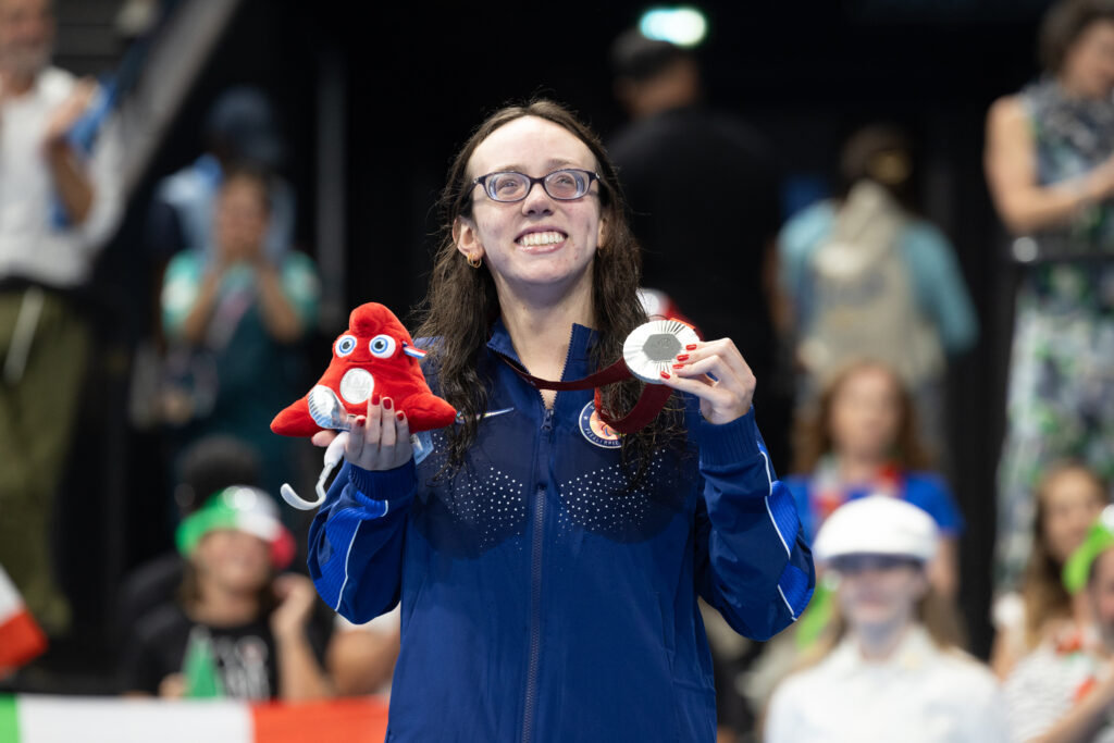 Team USA swimmer Grace Nuhfer stands on the Paralympic podium with her silver medal