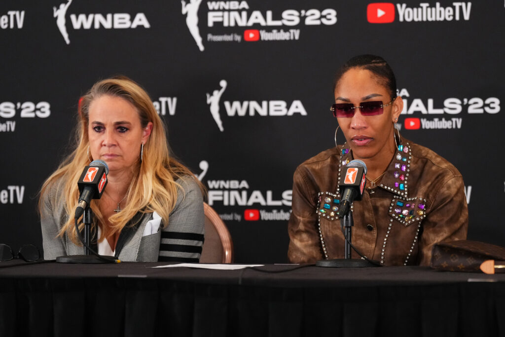 Aces head coach Becky Hammon and A'ja Wilson listen to a question during a press conference.