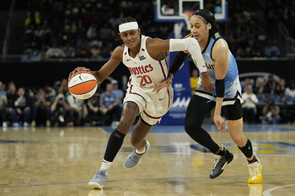 WNBA star Brittney Sykes of the Washington Mystics dribbles the ball against Chennedy Carter of the Chicago Sky.