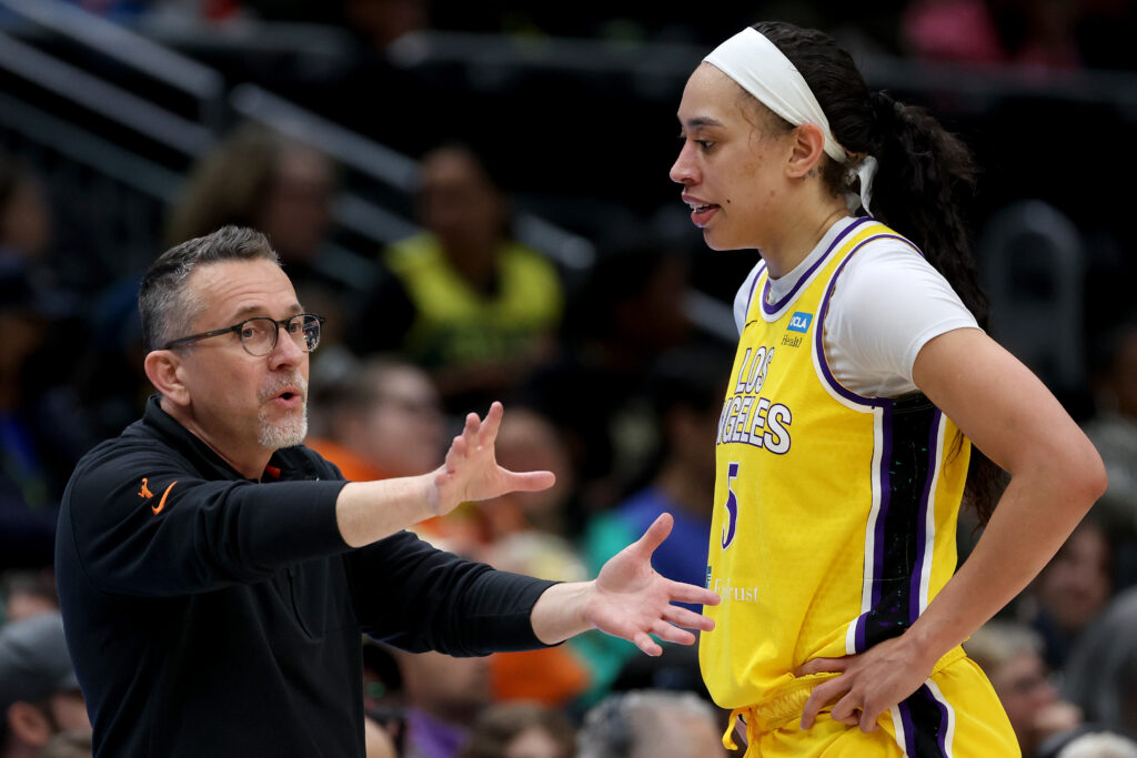 LA Sparks head coach Curt Miller talks with WNBA All-Star Dearica Hamby on the court