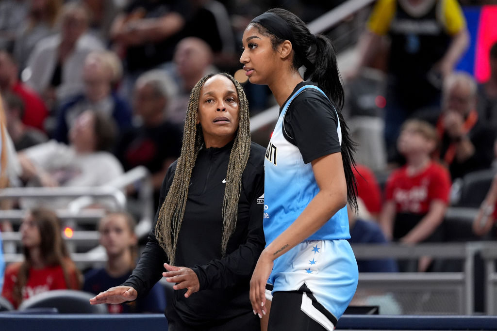 Angel Reese of the Chicago Sky talks to head coach Teresa Weatherspoon during a 2024 WNBA game against the Indiana Fever.