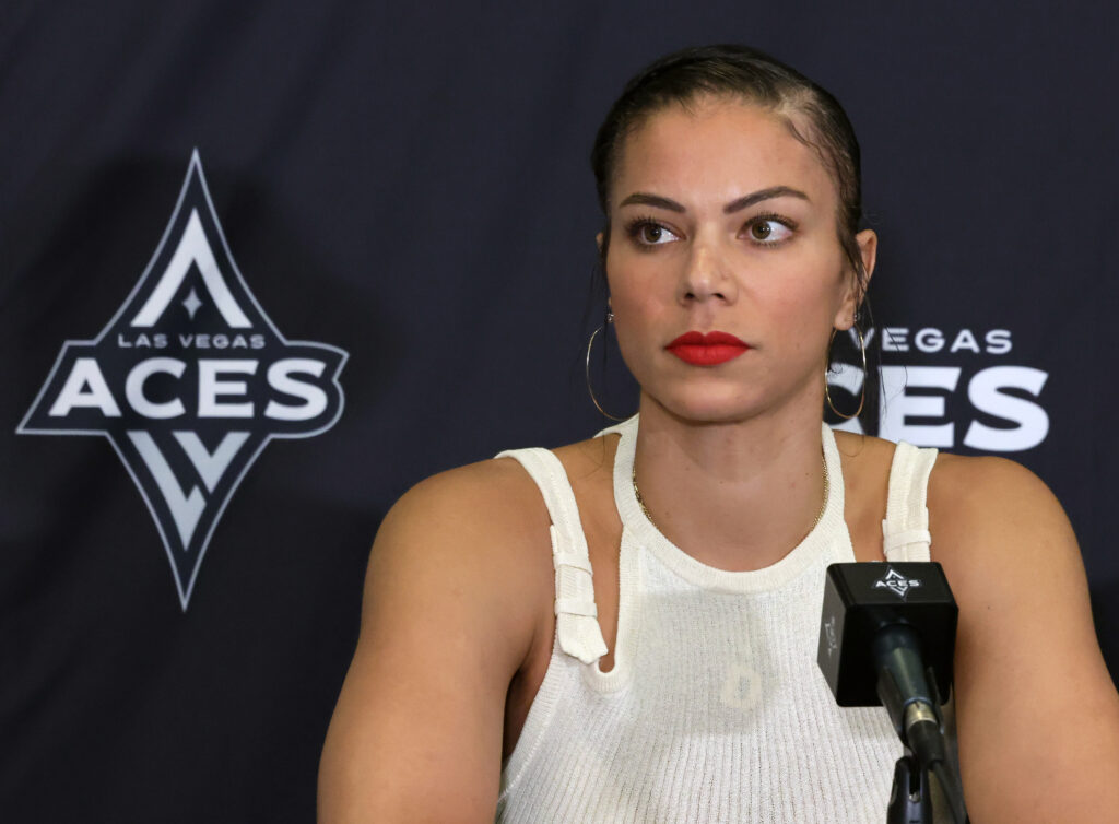 WNBA star Alysha Clark of the Las Vegas Aces listens to press questions at a news conference.