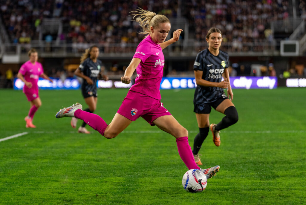 San Diego defender Kristen McNabb crosses the ball