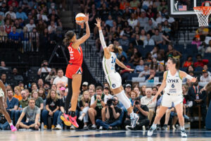 Las Vegas's A'ja Wilson shoots the ball over fellow 2024 WNBA Defensive Player of the Year contender, Minnesota's Napheesa Collier.