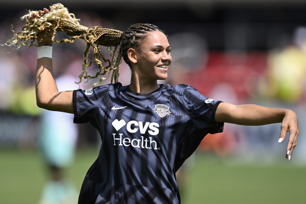 Trinity Rodman strikes a pose while celebrating a goal.