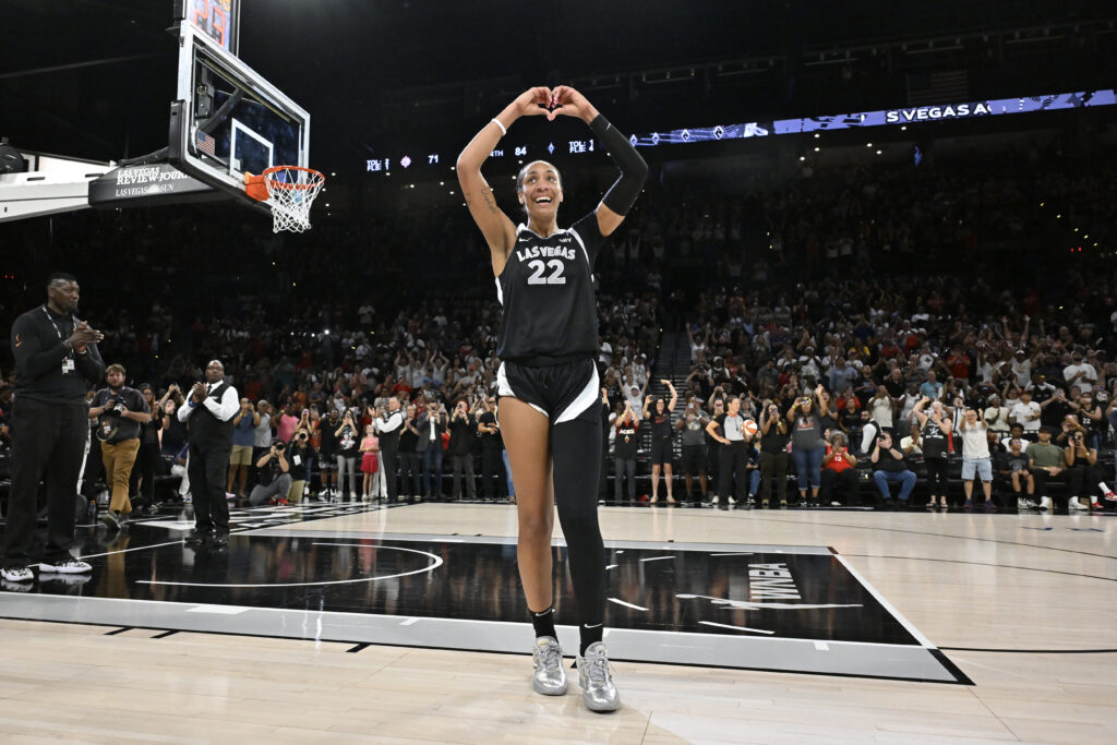 A'ja Wilson makes a heart with her hands as the Las Vegas crowd cheers her 1,000-point record.