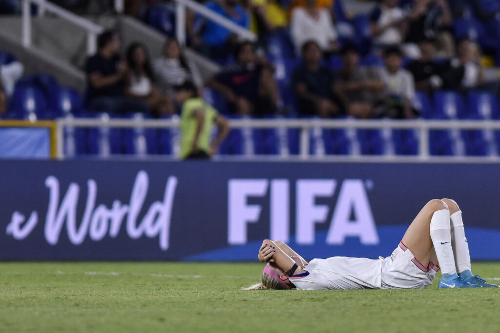 Maddie Dahlien lays on the pitch covering her face after the US's 2024 U-20 World Cup semifinal loss