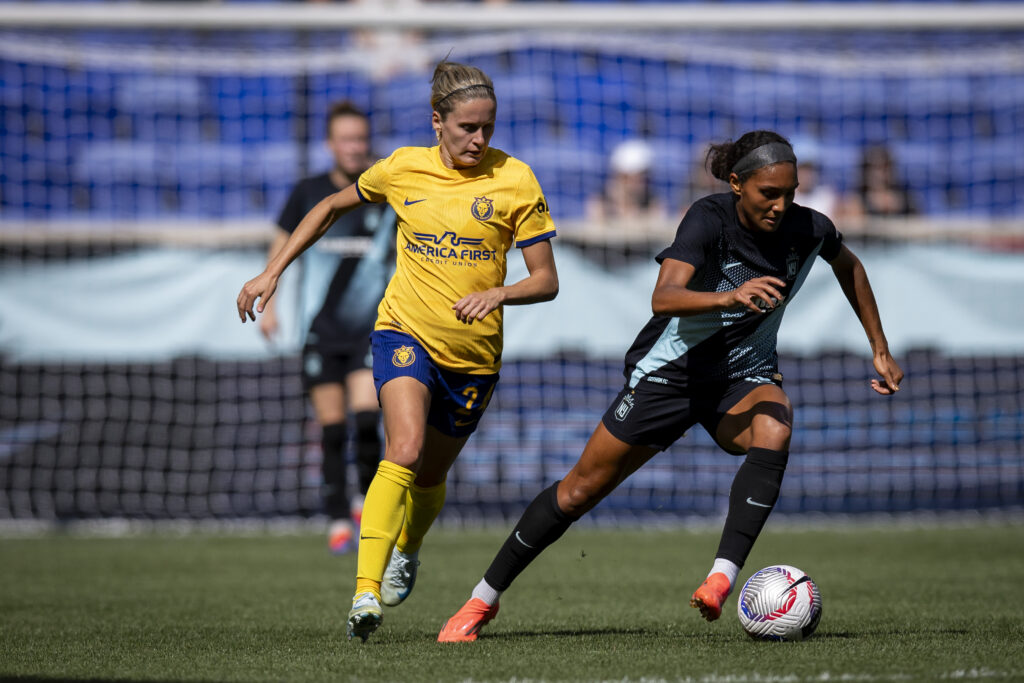 Gotham's Yazmeen Ryan dribbles past a Utah defender in a NWSL game.