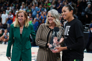 Napheesa Collier of the Minnesota Lynx accepts the 2024 WNBA Defensive Player of the Year award from WNBA Commissioner Cathy Engelbert.