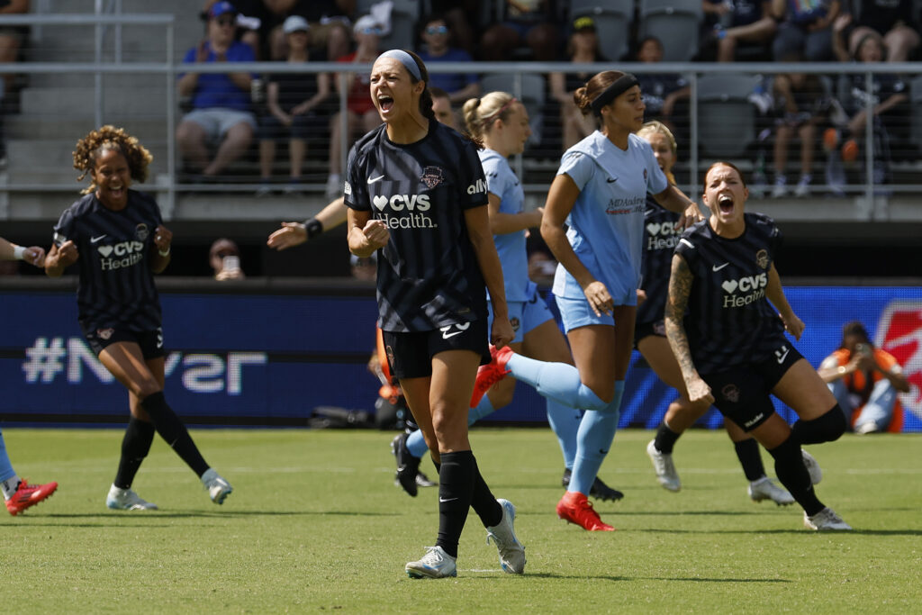 Washington striker Ashley Hatch celebrates a penalty kick goal.