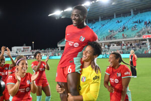 KC goalkeeper AD Franch lifts up Temwa Chawinga after a match.