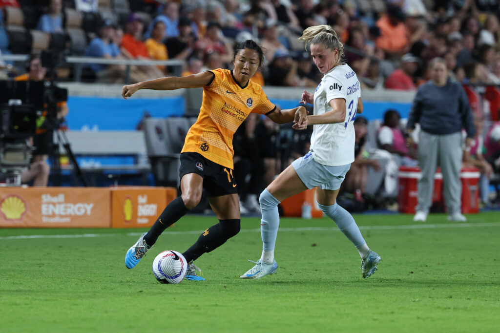 Houston's Yuki Nagasato dribbles around Seattle's Ana-Maria Crnogorcevic.