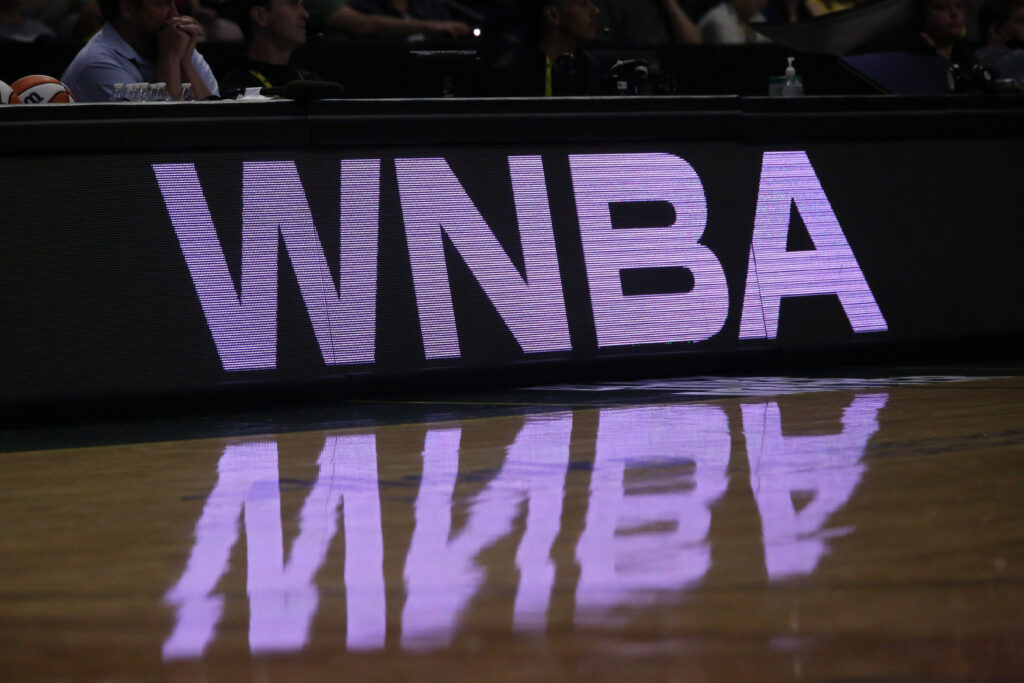 A purple and black WNBA sign