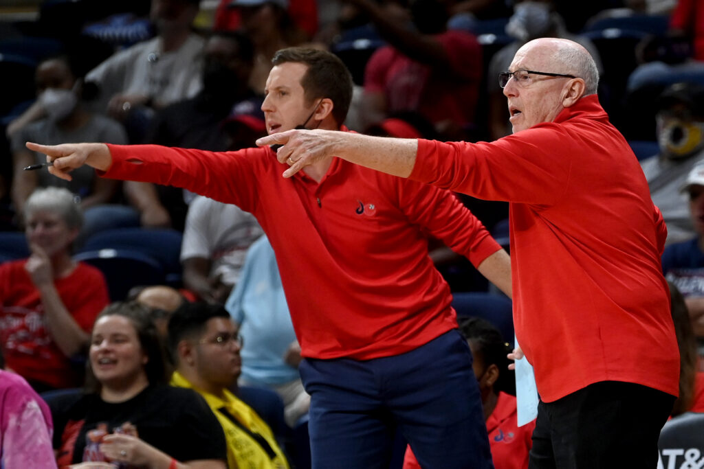 Former Mystics head coaches Eric and Mike Thibault react to a call during a game.