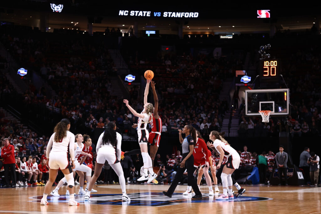 Cameron Brink of the Stanford Cardinal and Saniya Rivers of the NC State Wolfpack jump for the opening tip off during the Sweet Sixteen round of the 2024 NCAA Women's Basketball Tournament.