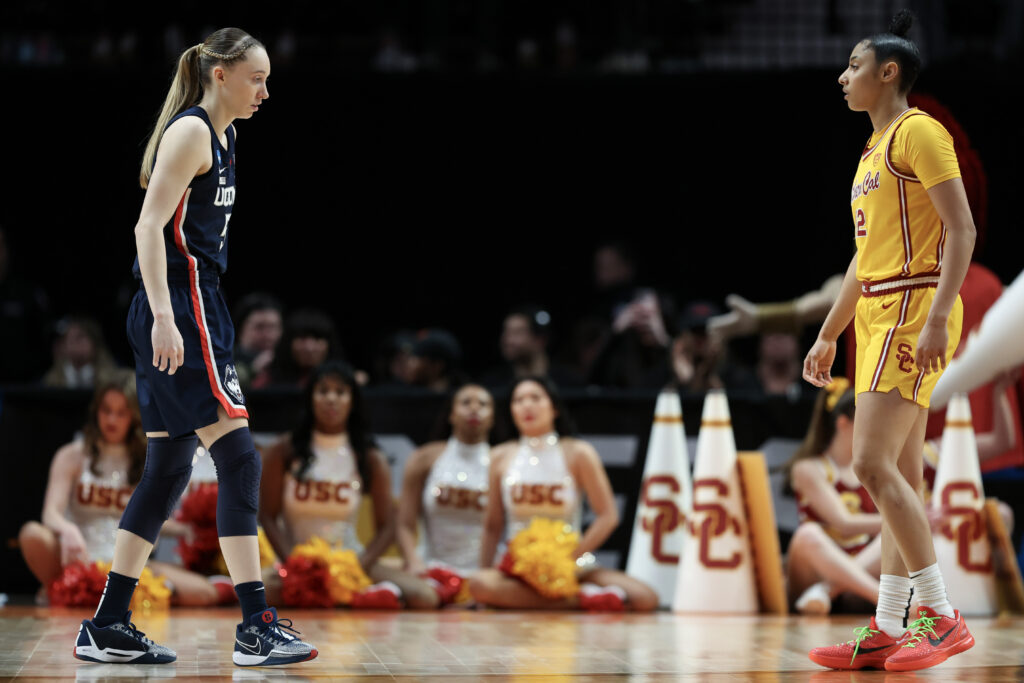 UConn's Paige Bueckers and USC's JuJu Watkins face each other during an NCAA women's college basketball game.