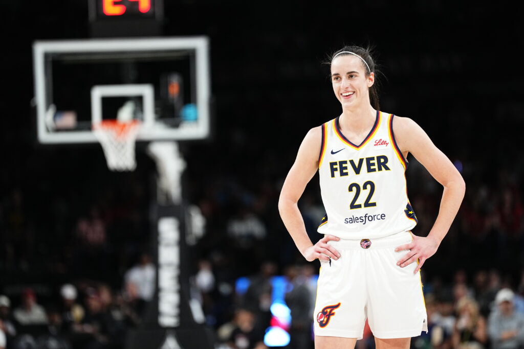 Caitlin Clark smiles during a game.