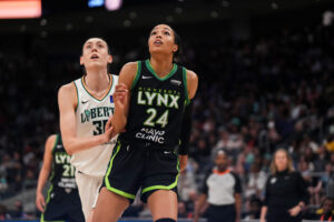 New York's Breanna Stewart and Minnesota's Napheesa Collier look up during a game.