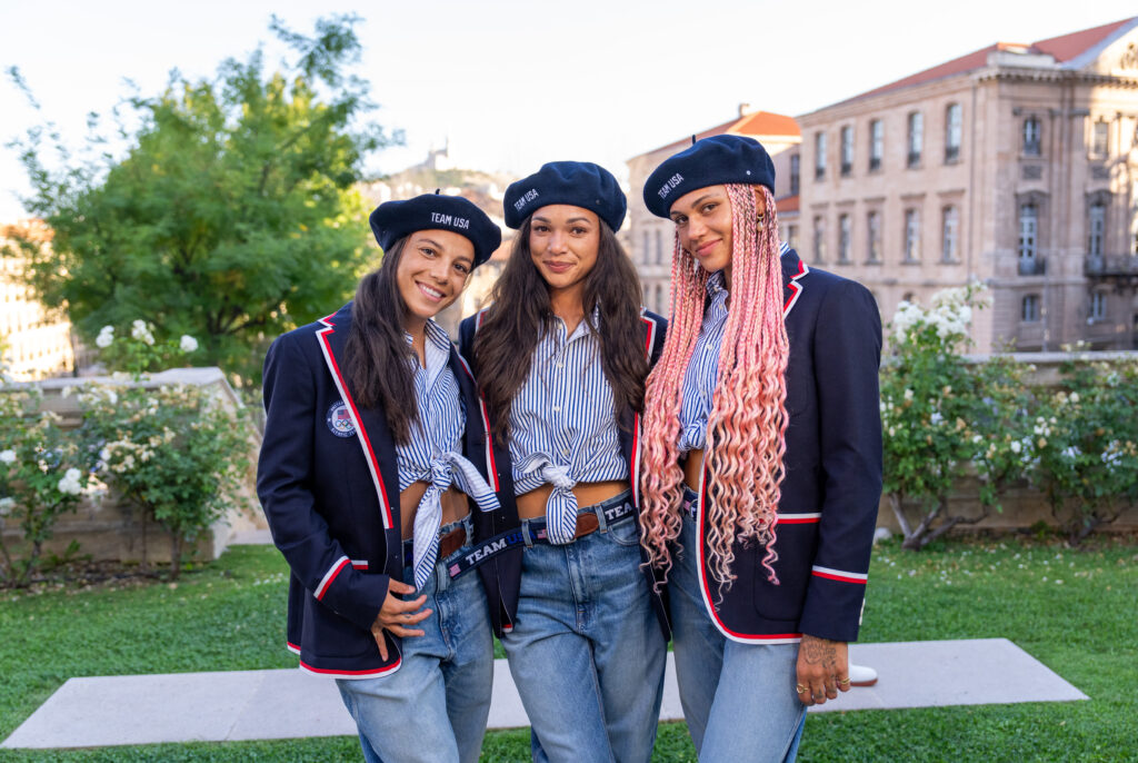 USWNT players Mal Swanson, Sophia Smith, and Trinity Rodman post in their Team USA swag at the 2024 Olympics.