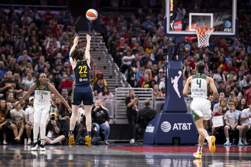 Caitlin Clark shoots a long-range three-pointer during a game.