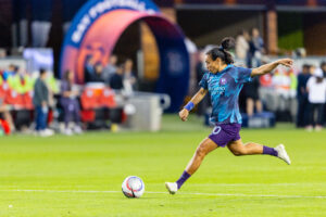 Orlando Pride star Marta strikes the ball during a match.