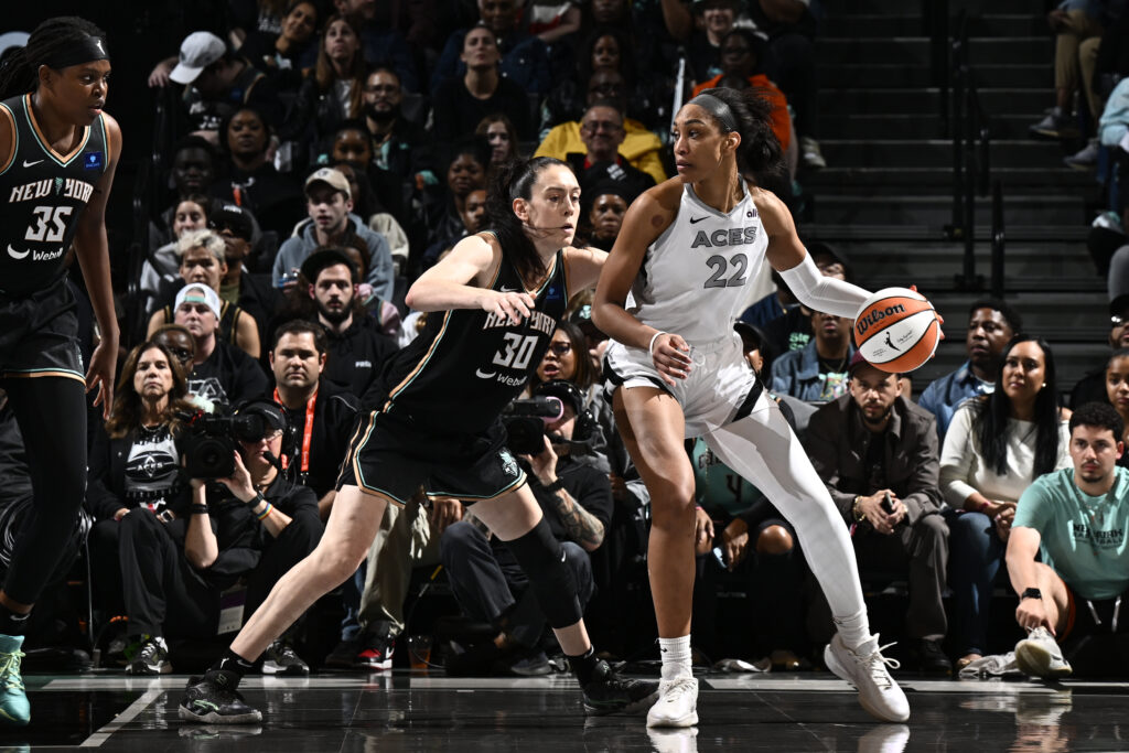 Aces center A'ja Wilson dribbles against the Liberty's Breanna Stewart in the 2024 WNBA semifinals.