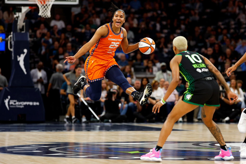 Connecticut's Alyssa Thomas leaps with the ball