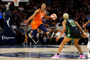 Connecticut's Alyssa Thomas leaps with the ball