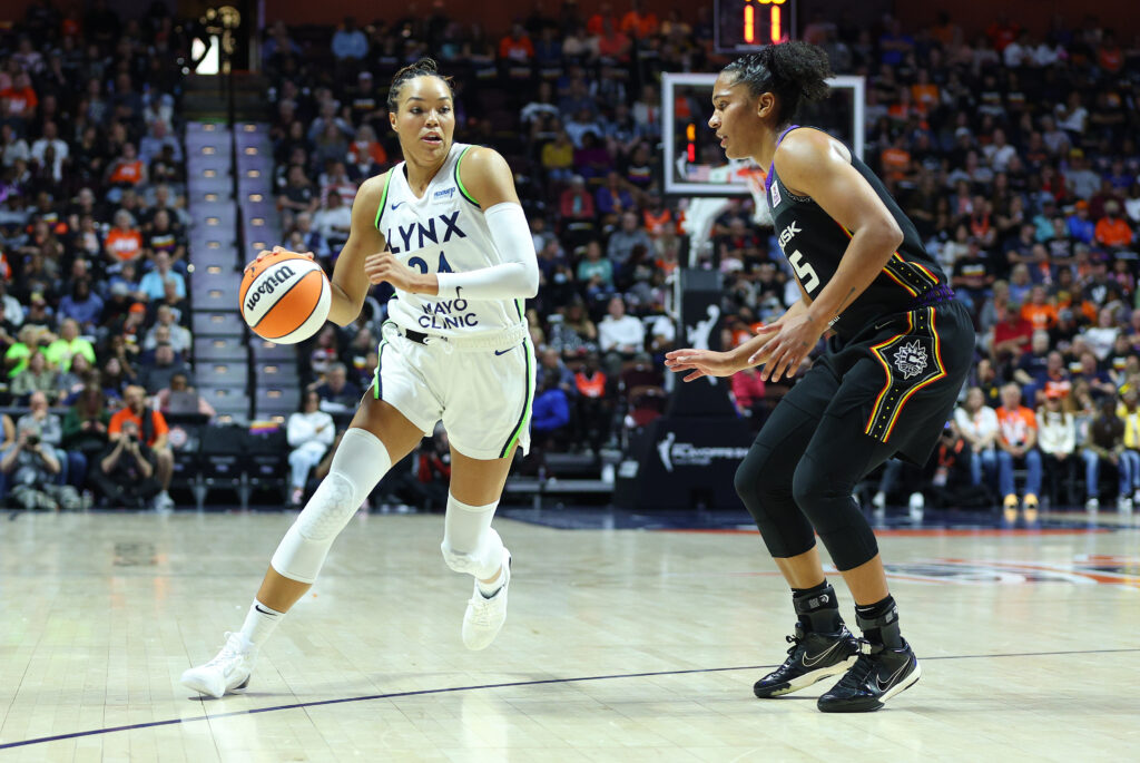 Minnesota's Napheesa Collier dribbles around Connecticut's Alyssa Thomas