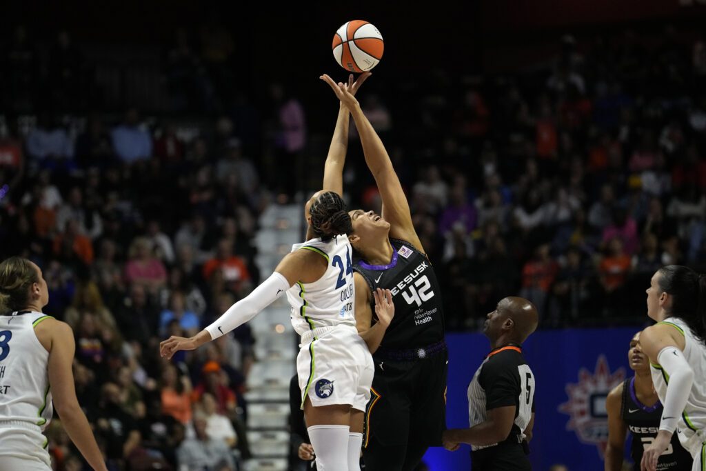 Minnesota's Napheesa Collier and Connecticut's Brionna Jones jump for the ball