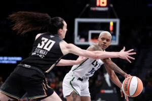 Minnesota's Courtney Williams looks to pass around New York's Breanna Stewart