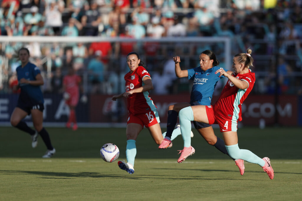 Kansas City defender Hailie Mace and Chicago forward Mal Swanson battle for the ball in an NWSL game.