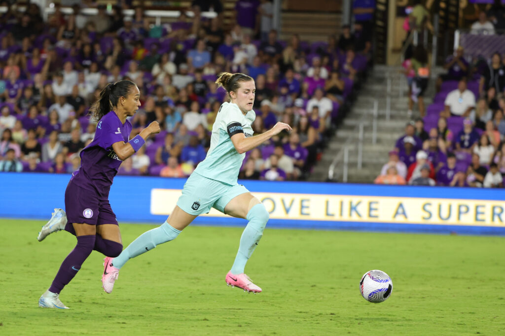 Orlando's Adriana and Gotham's Tierna Davidson chase the soccer ball in an NWSL game.