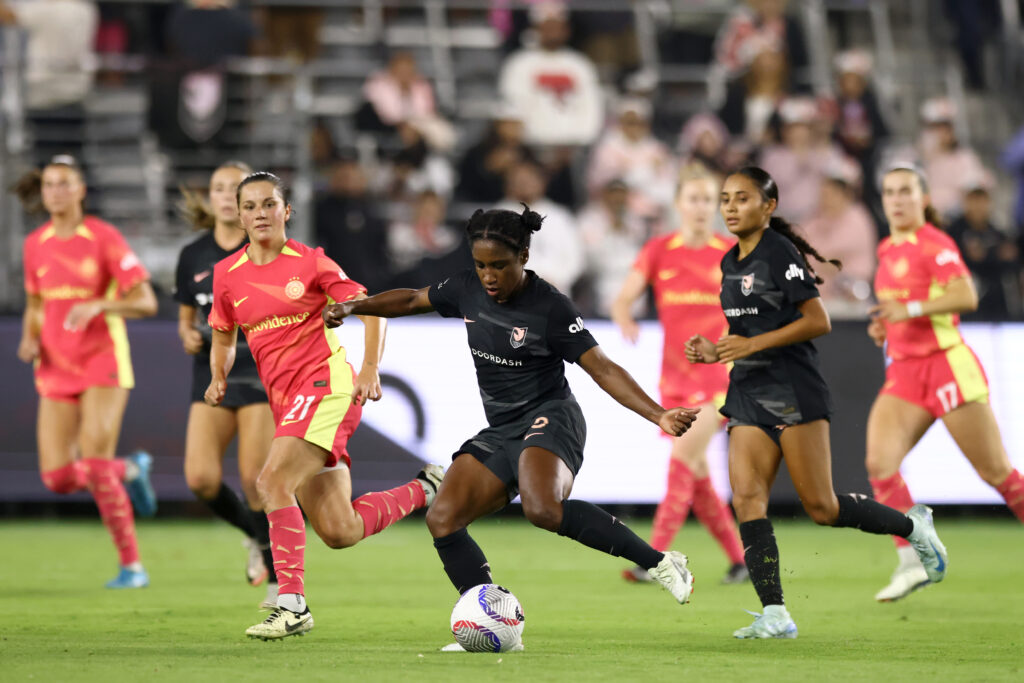 Angel City defender Jasmyne Spencer kicks the ball during an NWSL game against Portland.