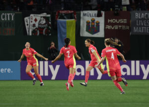 Portland's Christine Sinclair celebrates a goal with her teammates